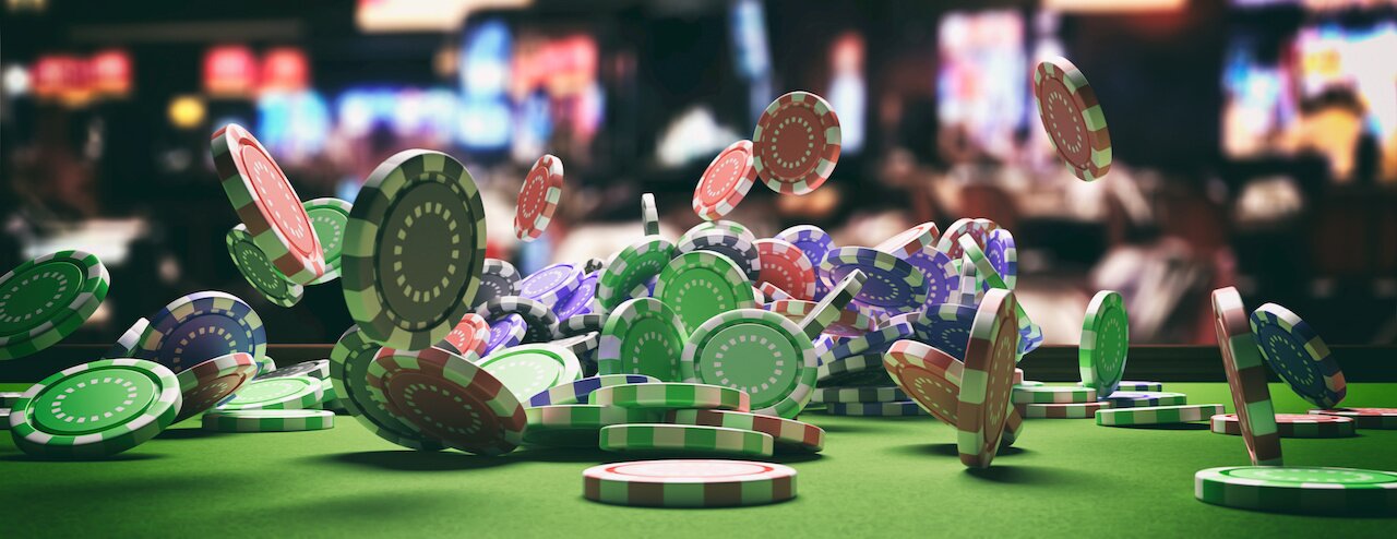 Casino poker concept. Poker chips falling on green felt roulette table, blur casino interior background, banner. 3d illustration