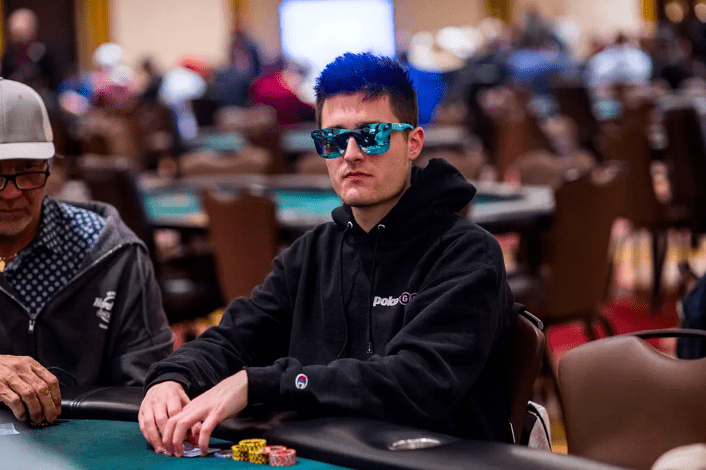 Jeremy Becker with sunglasses on and playing poker