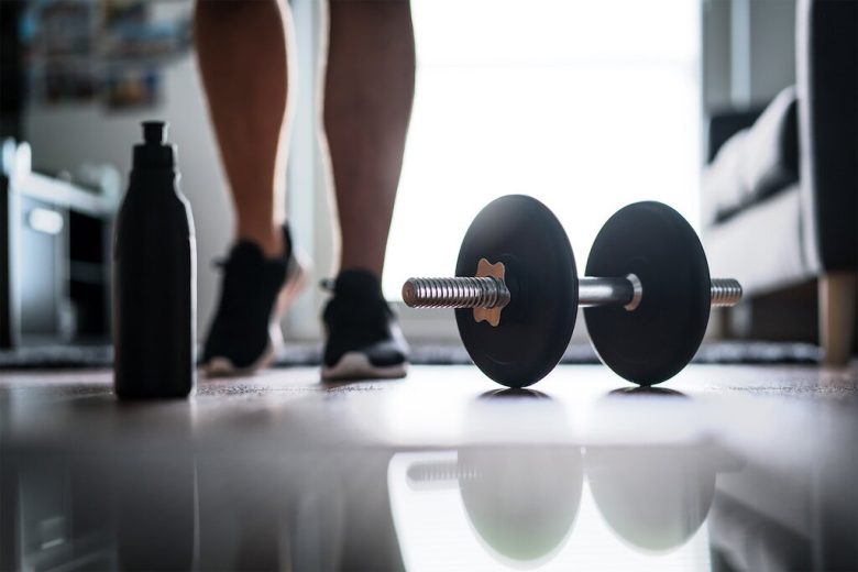 a person standing behind a dumbell