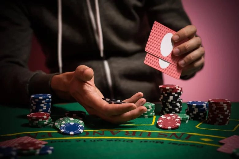 man playing poker with chips in his hand