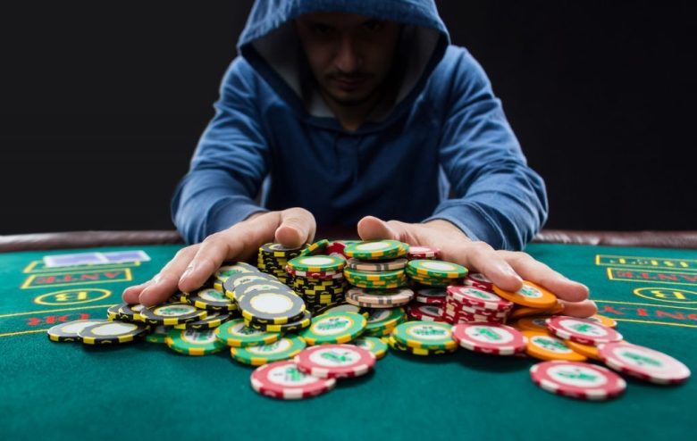 Man pushing a stack of chips in the middle of the table