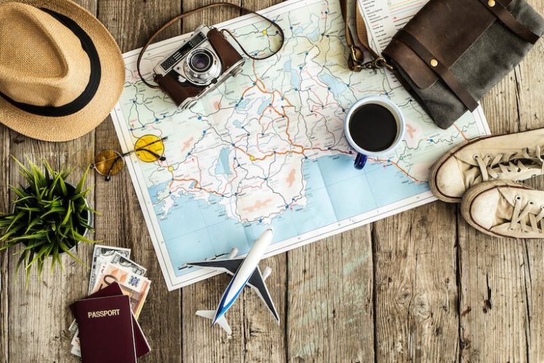 Map with camera, passport, and other items near it