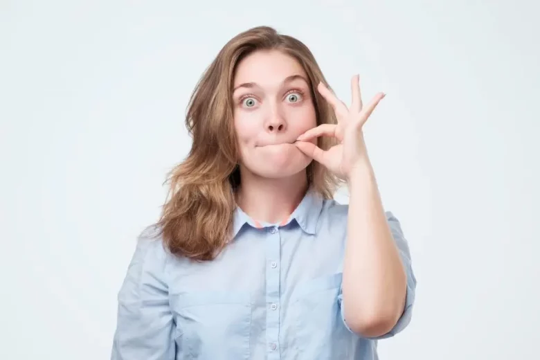 Woman making a zip it face with mouth closed