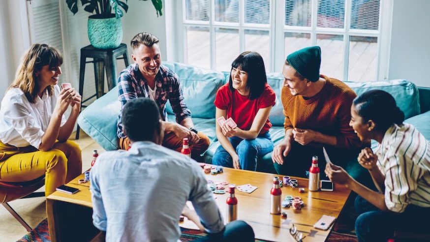 a bunch of friends playing poker at home