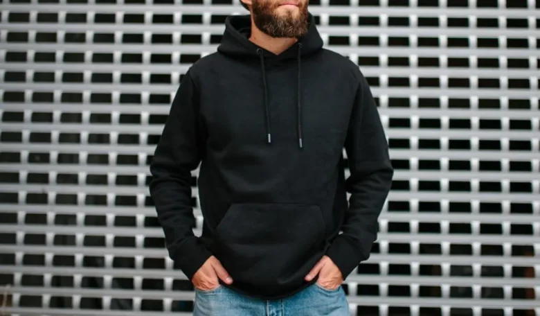 A man in a black hoodie