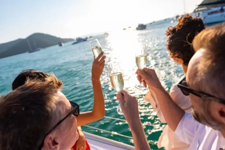 people on a boat cheersing champagne