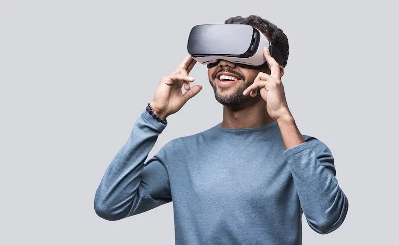 Man with blue shirt wearing a VR headset