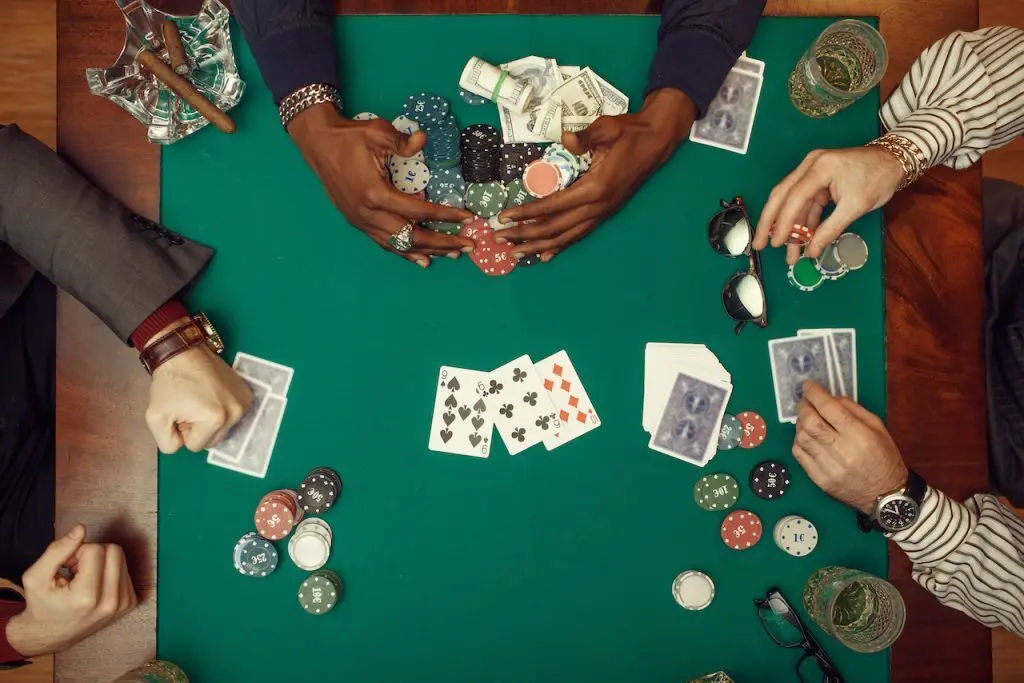 people playing a poker game for cash