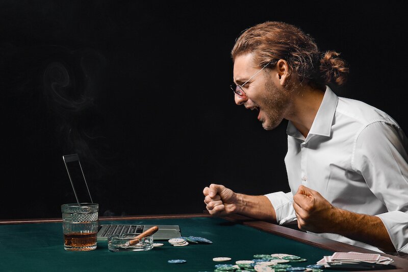 Emotional young man playing poker online