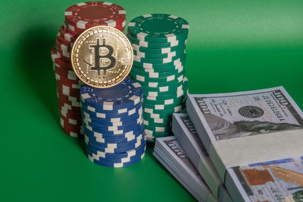 poker chips and cash with a bitcoin on it