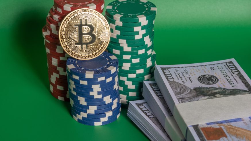 poker chips and cash with a bitcoin on it