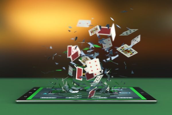 an ipad with poker cards being shot out of the screen