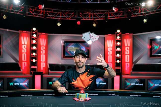 Brian Rast throwing his cards in the air after winning the WSOP PPC