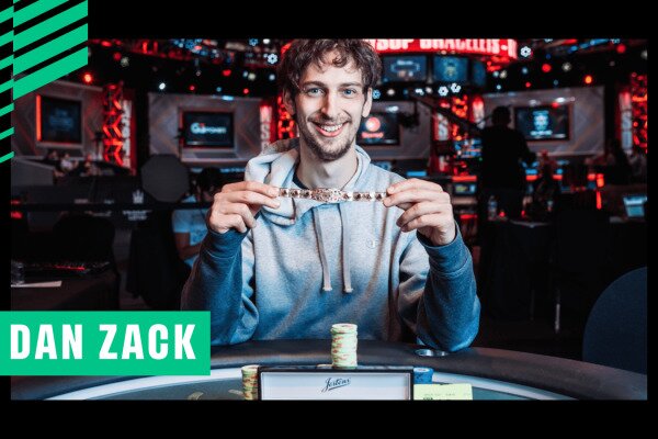 Poker player Dan Zack is smiling while holding a World Series of Poker