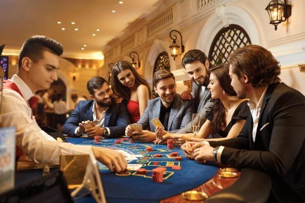 friends laughing and playing poker together