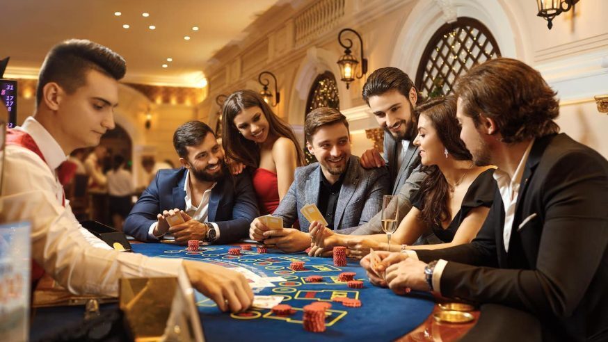 friends laughing and playing poker together