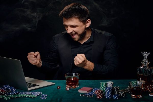 Man celebrating winning at online poker