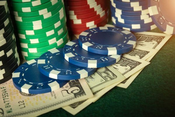 Poker chips on cash bills