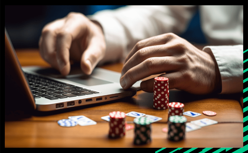 Someone learning how to play poker on their laptop, with poker chips on their desk.