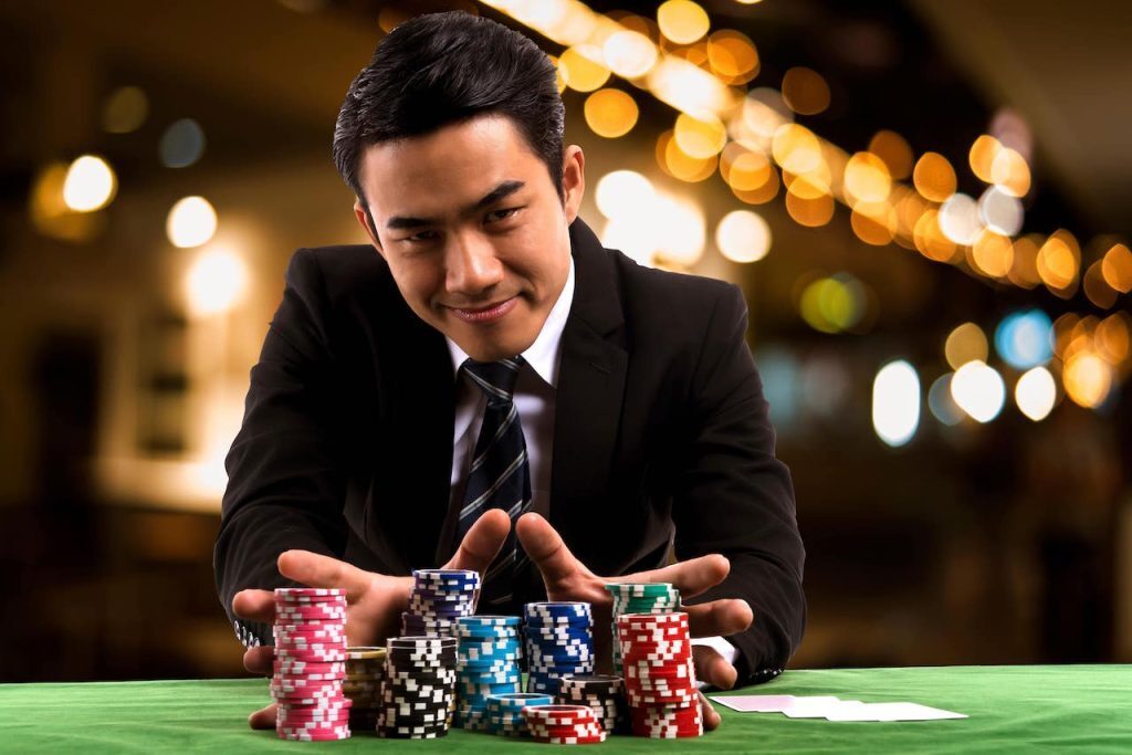 man confidently putting chips into the pot