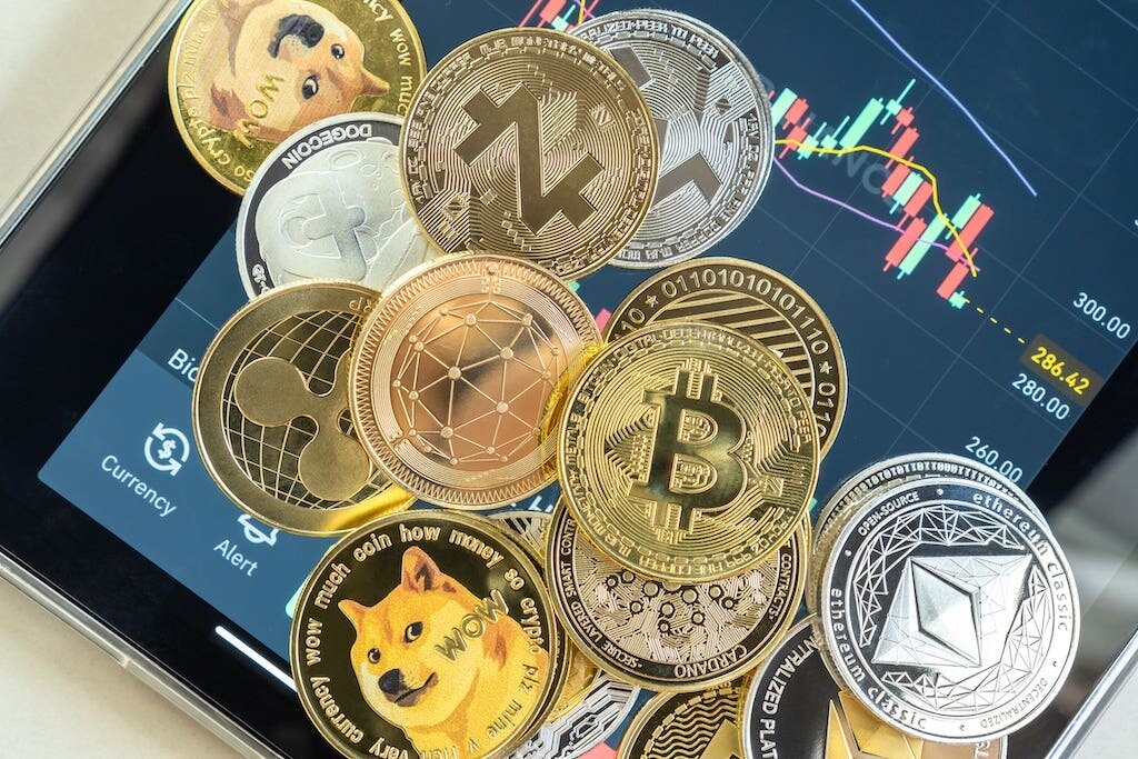 Cryptocurrency coins on an ipad with trading charts