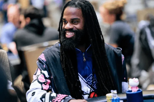 Justin Arnwine smiles at a poker table