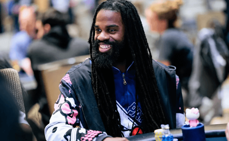 Justin Arnwine smiles at a poker table